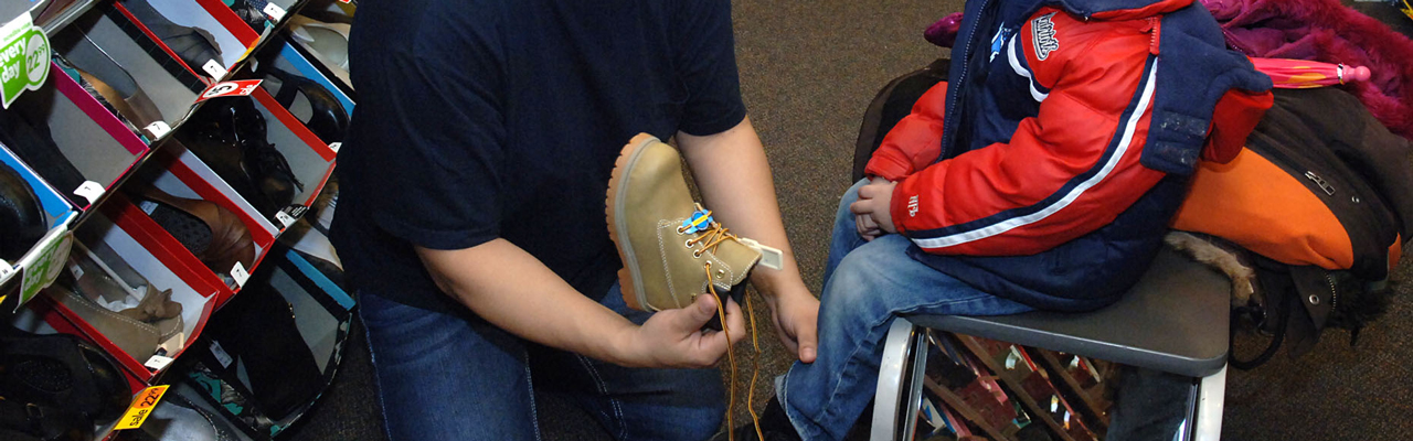 Child receiving winter boots