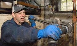 man fixing heating systems